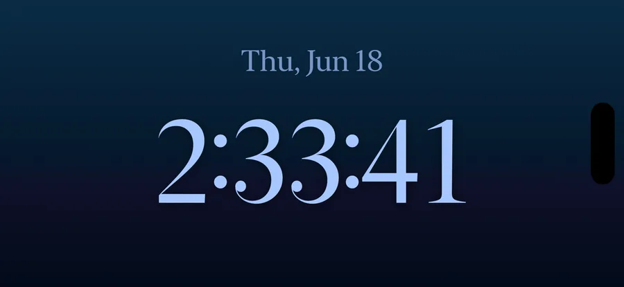 Live Seconds Nightstand Mode: a full-screen landscape clock showing the date, hours, minutes and seconds
